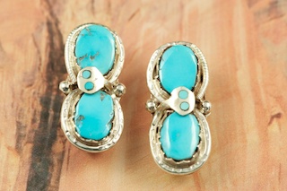 Genuine Turquoise set in Sterling Silver Clip on Earrings. Created by Zuni Artist Effie Calavaza. A signature trademark of Effie's is the snake symbol, entwined around Turquoise on Sterling Silver. Signed Effie C. Zuni.